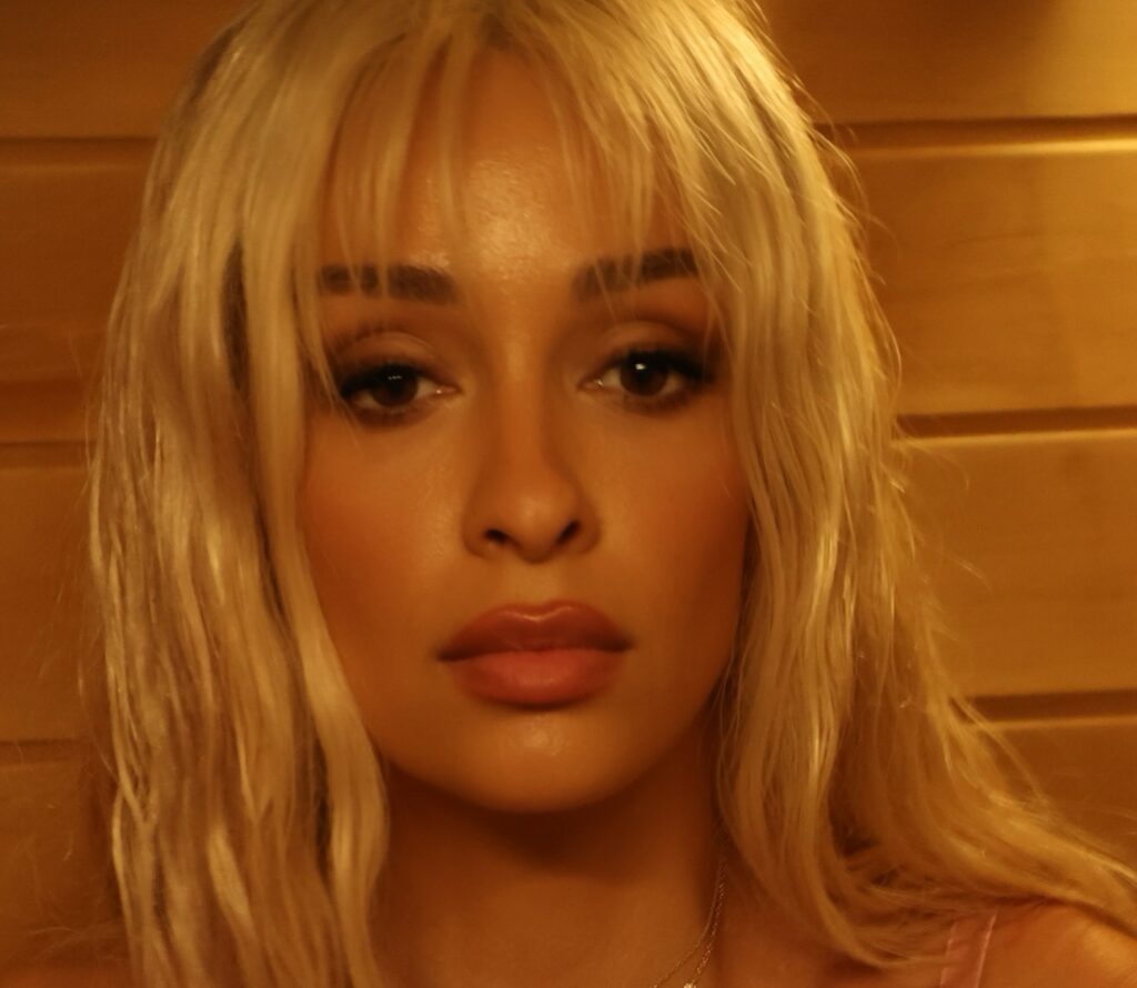 Photo by Eleni Foureira on July 16 2024. May be an image of 1 person blonde hair lipstick makeup eyeliner and text