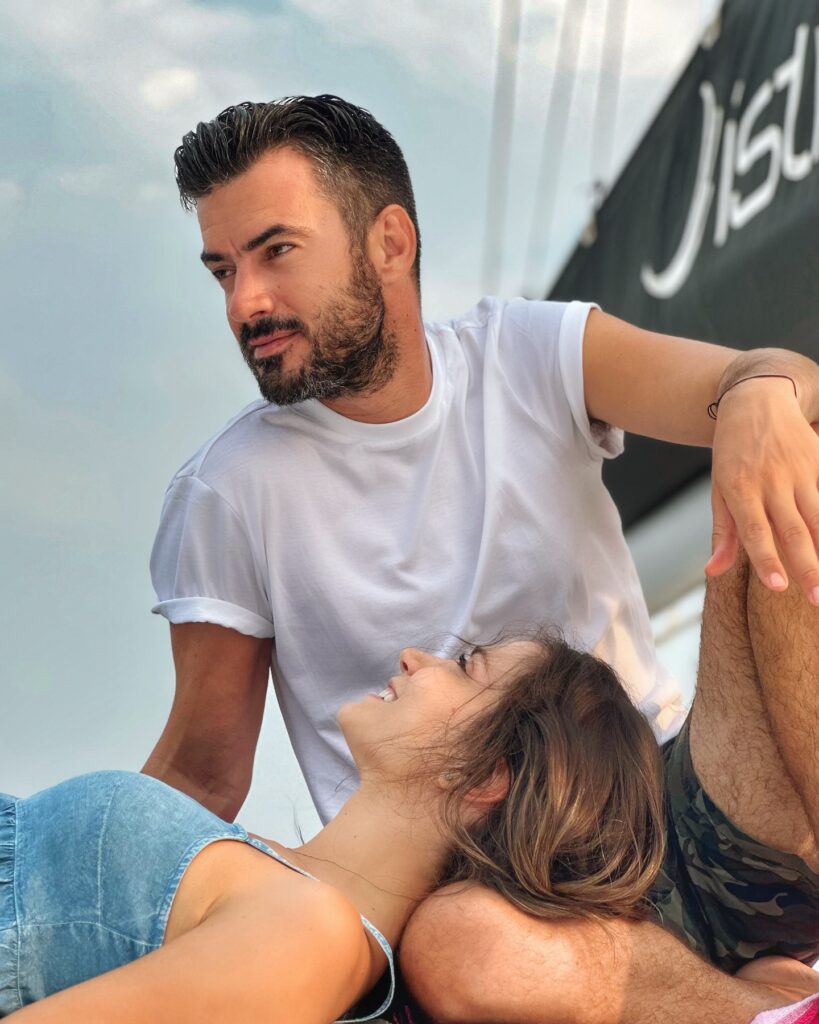 Photo shared by Katerina Geronikolou on July 28 2024 tagging @gtsimitselis and @istionyachting. May be an image of 1 person beard people kissing yacht outdoors and text